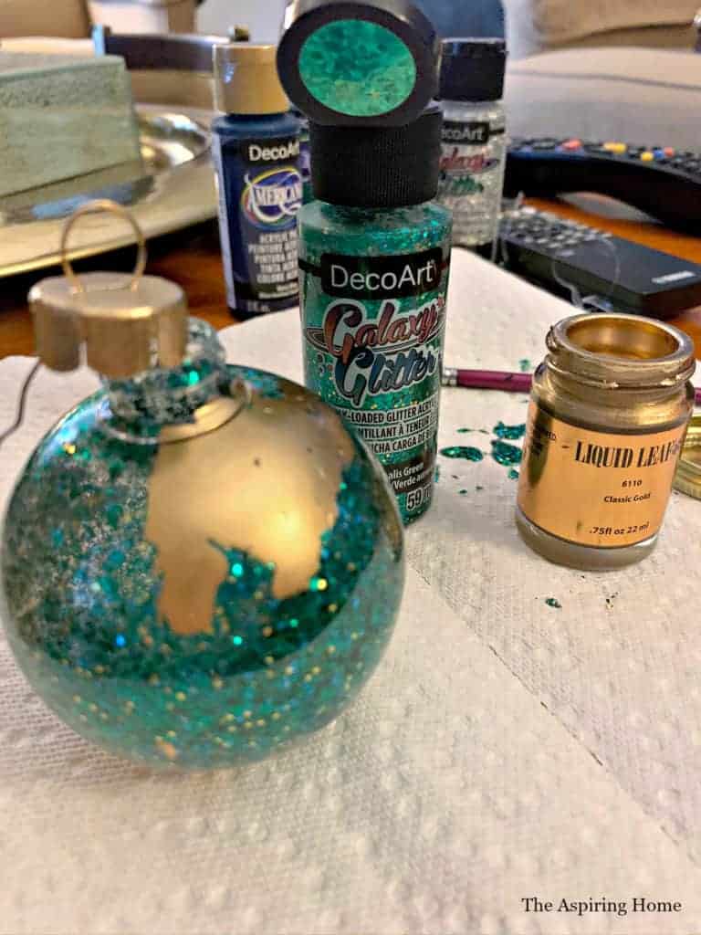 Add gold leaf  to create the glitter and gold Christmas ornament