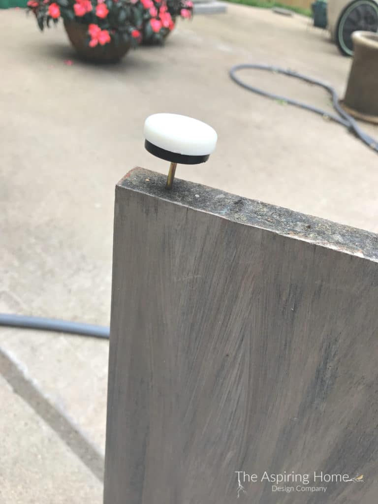 Add Button feet to base of the DIY outdoor stone entry table