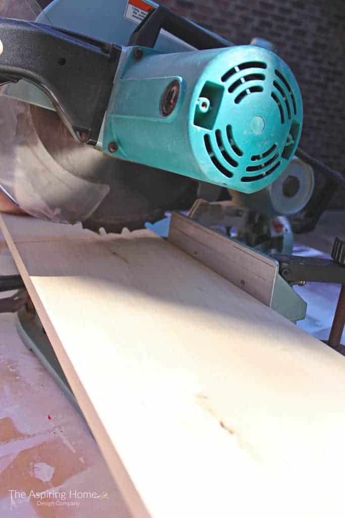 using a chop saw to make the cuts for the outdoor stone entry table