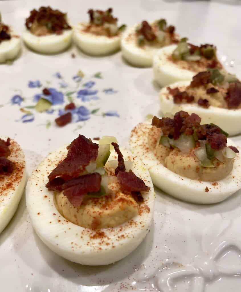 smokehouse stuffed eggs with bbq sauce, pickles, bacon by the aspiring home interiors. 