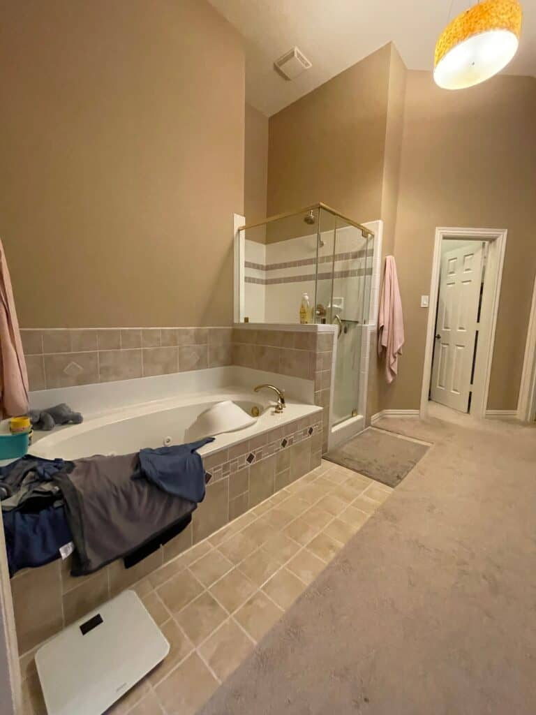 Before primary bathroom tub and shower view